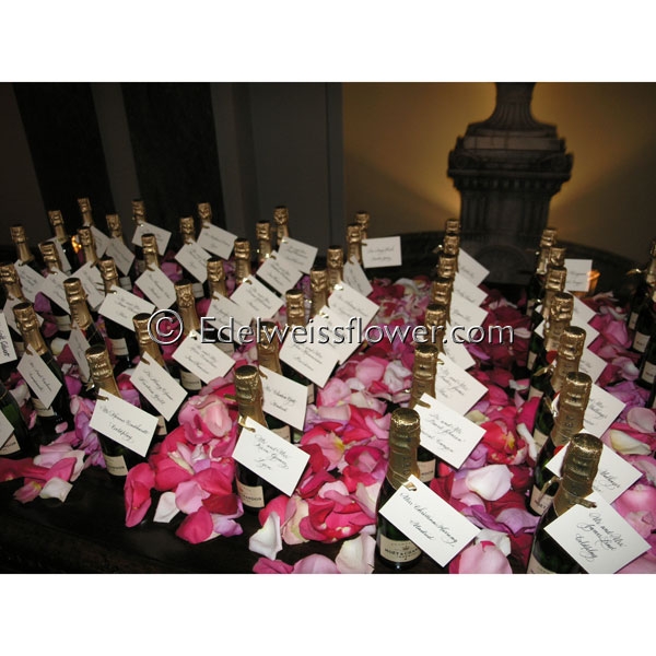 Wedding guest card table with champange bottles rose petals